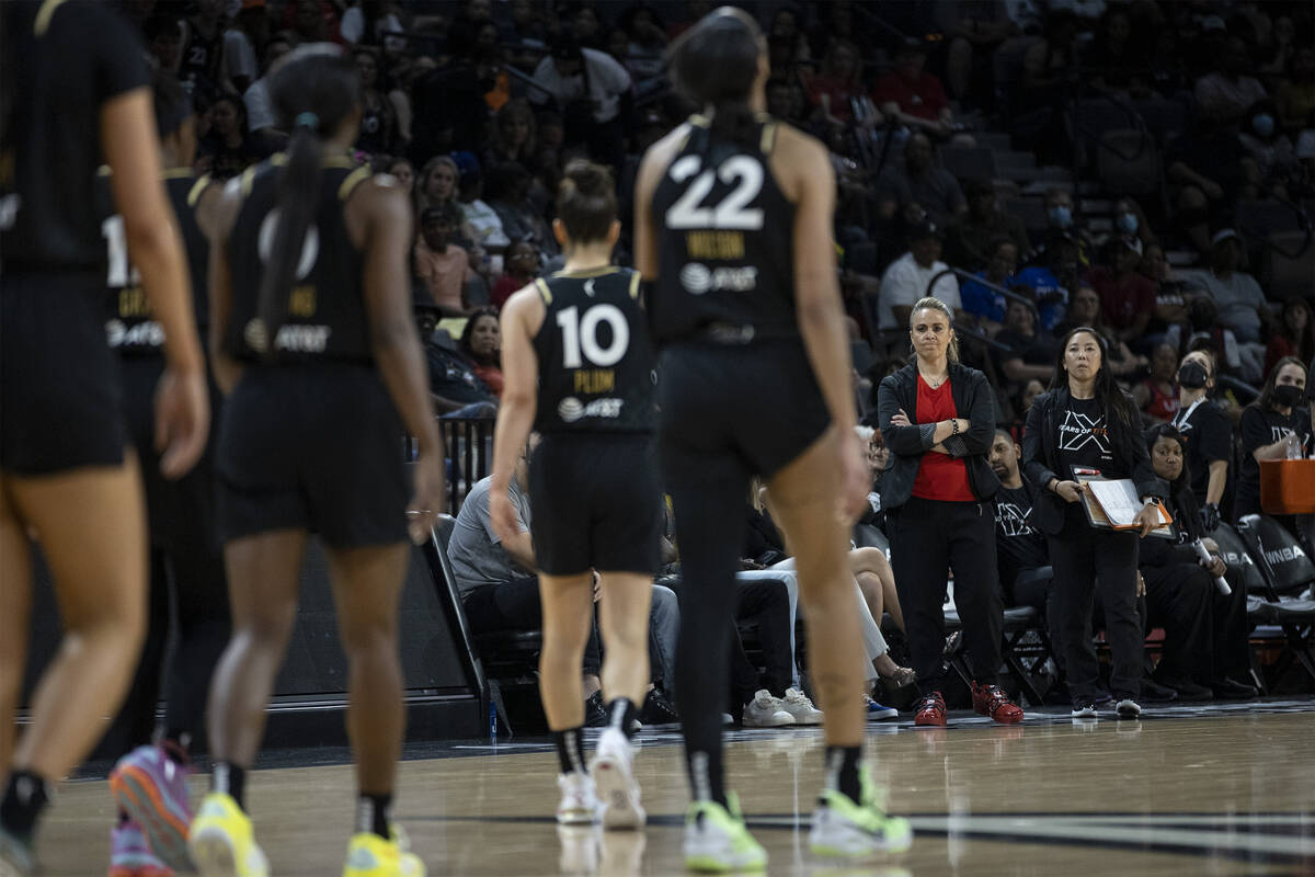 Las Vegas Aces head coach Becky Hammon, second from right, and assistant coach Natalie Nakase, ...