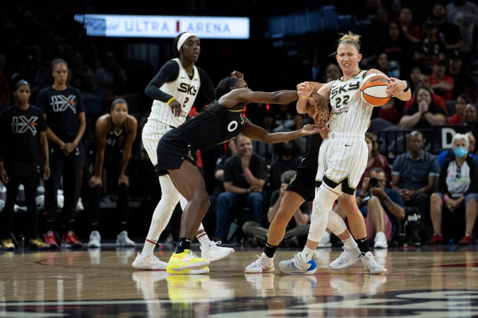 Las Vegas Aces guard Jackie Young (0) fouls Chicago Sky guard Courtney Vandersloot (22) while g ...