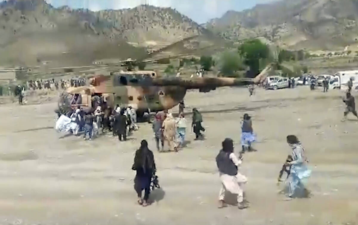 In this image taken from video from Bakhtar State News Agency, Taliban fighters secure a govern ...