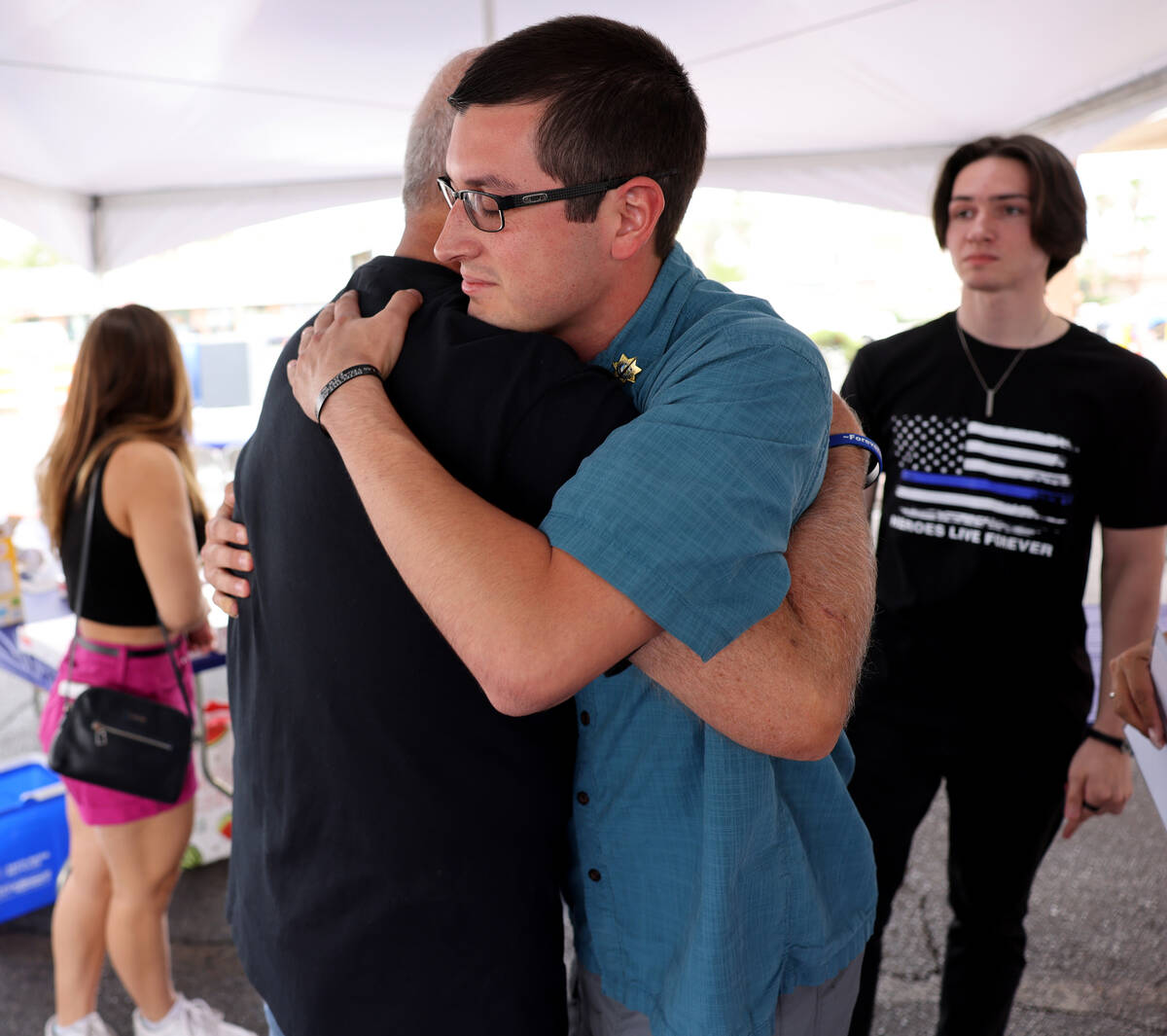 Sean Terry, son of late Las Vegas police Detective Justin Terry hugs retired Las Vegas police S ...