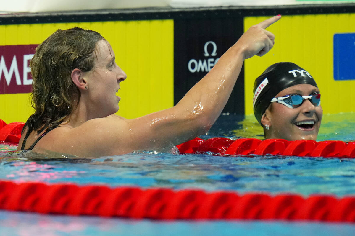 Katie Ledecky of the United States celebrates with second place Katie Grimes, right, also of th ...