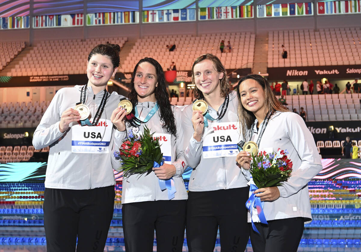 Gold medalist team of United States pose with their medals after the women's 4x200-meter freest ...