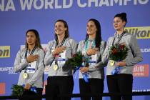 Gold medalist team of United States pose with their medals after the women's 4x200-meter freest ...