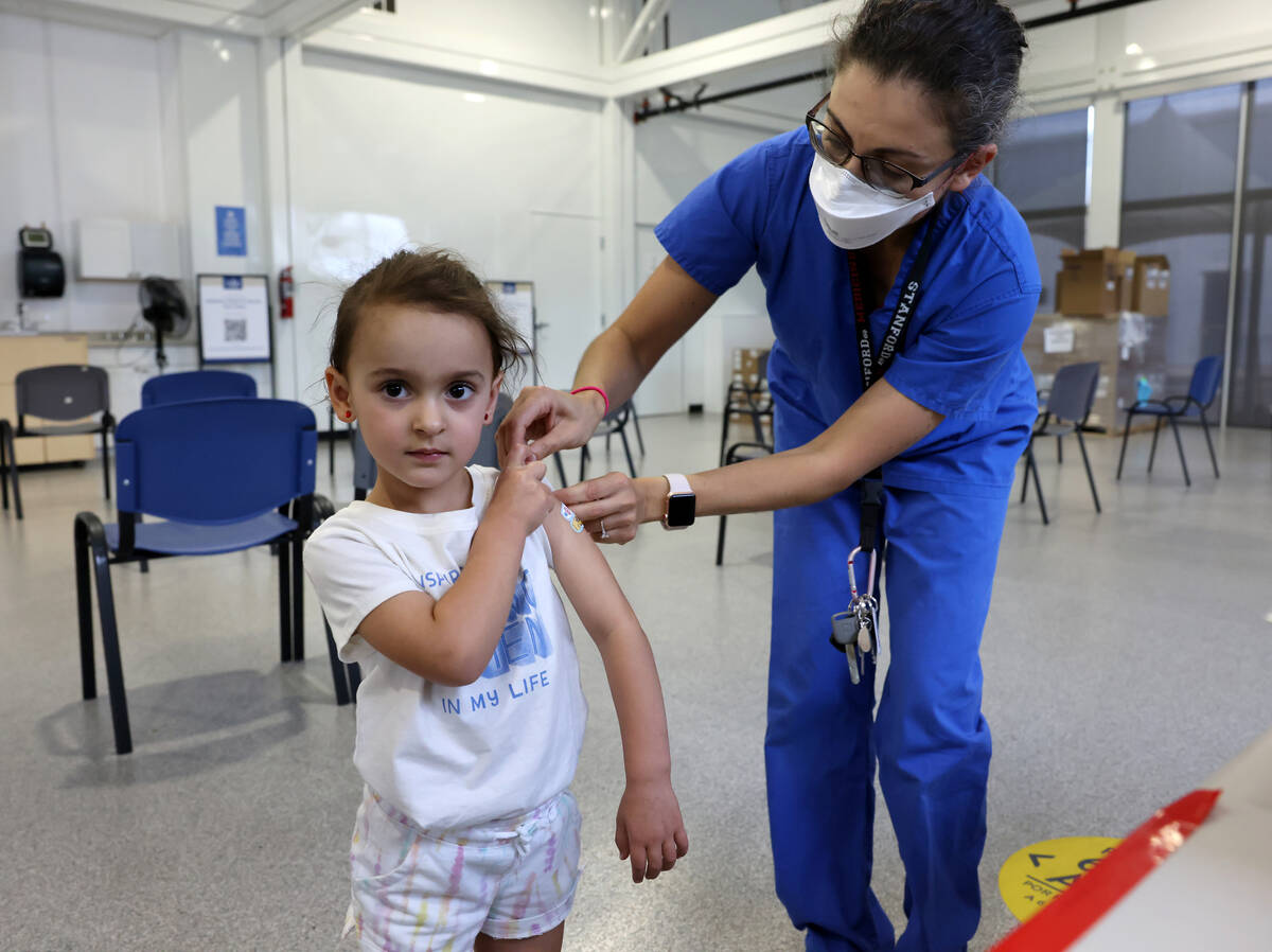 Mais Yacoub helps her 3-year-old daughter Quincy show off her Band-Aids after getting a COVID-1 ...