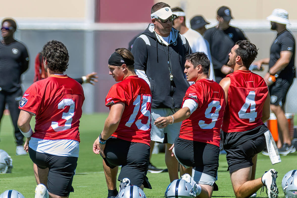 (Clockwise from top) Raiders head coach Josh McDaniels chairs with quarterback Derek Carr (4) a ...