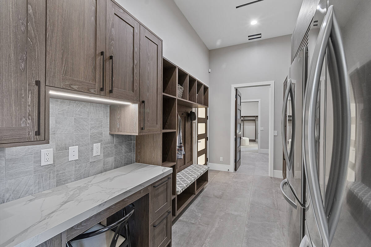 The laundry room has plenty of storage. (Darin Marques Group)