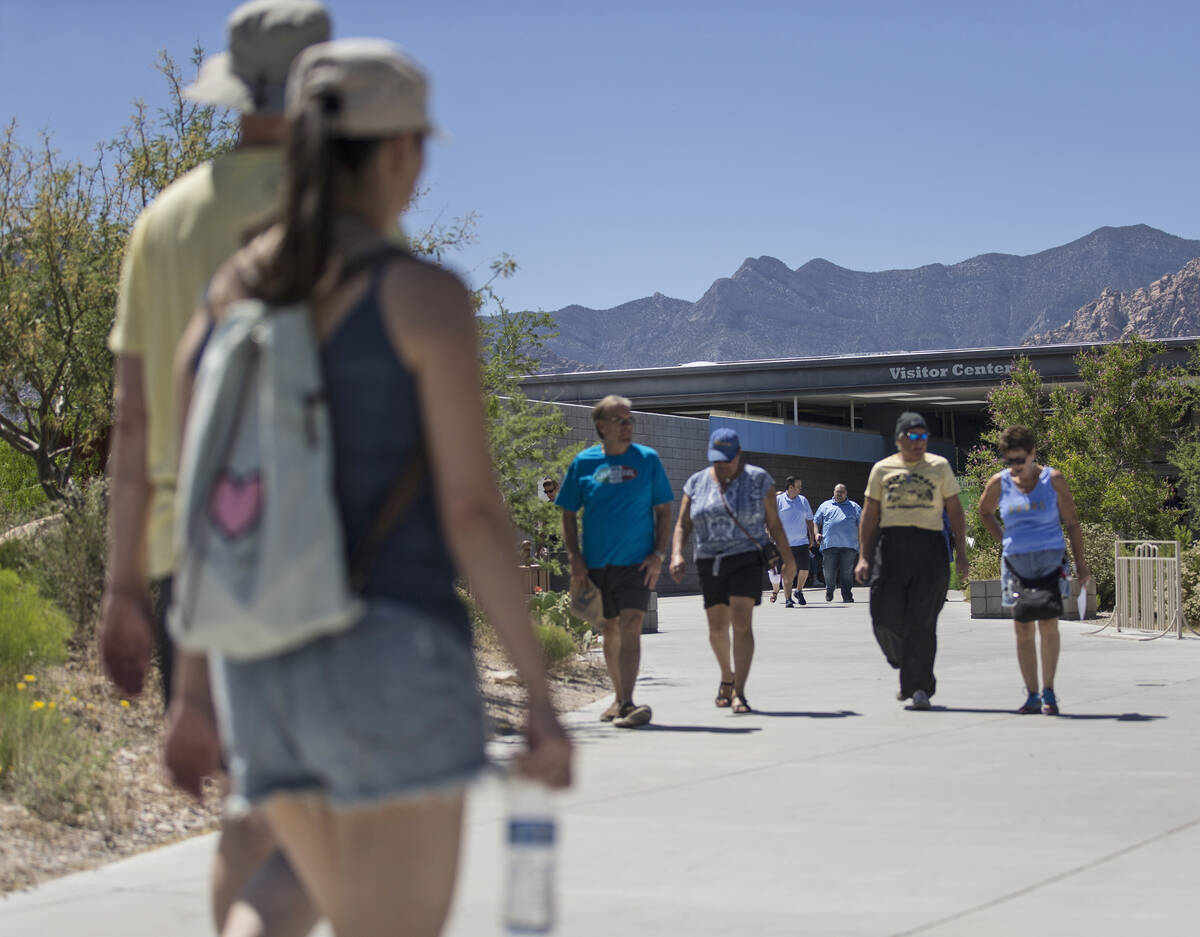 Groups of people come and go at the visitor center during "National Get Outdoors Day" ...