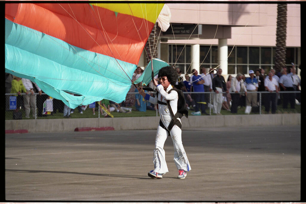 A member of The Flying Elvi skydiving team touches down between the Las Vegas Convention Center ...