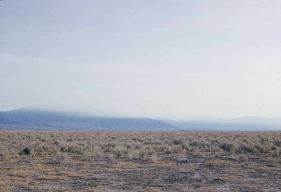 A dust cloud carrying fallout down the mountains from the Schooner test on December 8, 1968. Sc ...