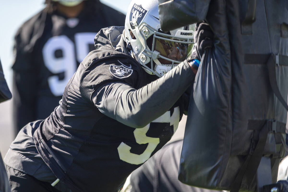 Raiders defensive end Malcolm Koonce (51) hits the tackle sled during a practice session at the ...