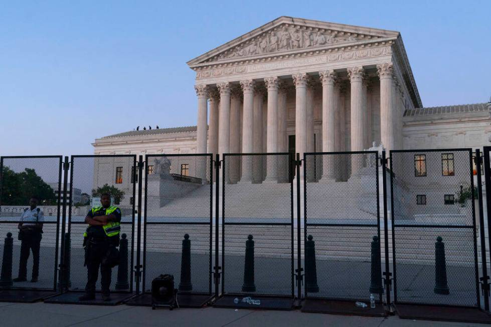 The Supreme Court is guarded at dusk, following the court's decision to overturn Roe v. Wade in ...
