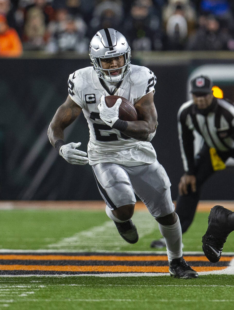 Raiders running back Josh Jacobs (28) runs into open field during the second half of an NFL pla ...