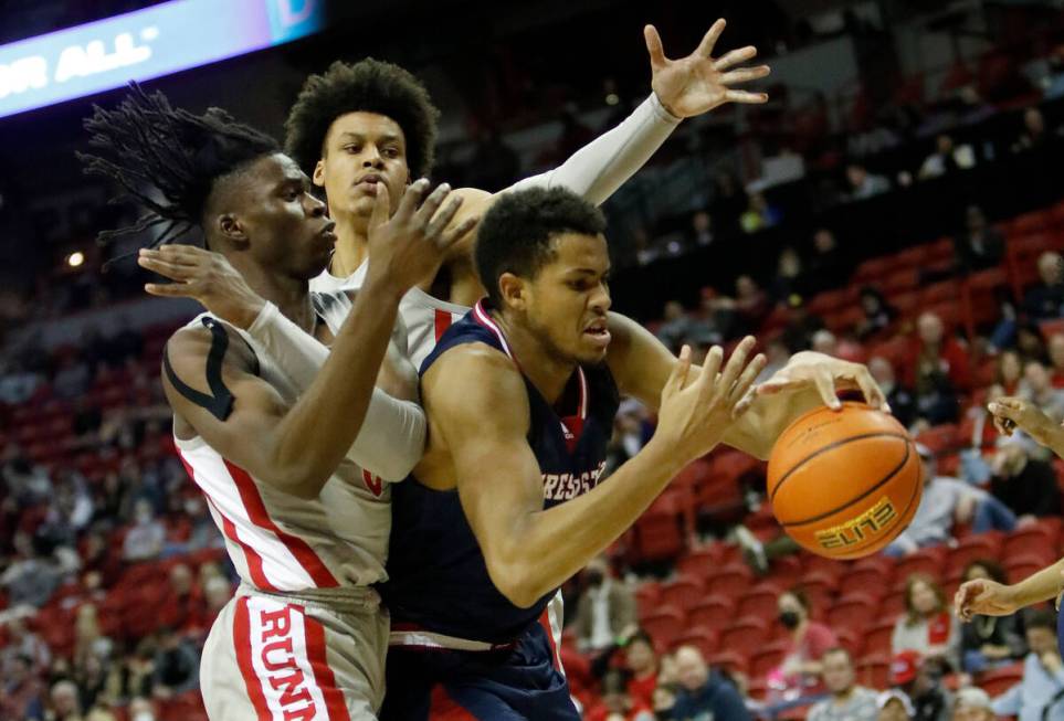 Fresno State Bulldogs forward Orlando Robinson (10), UNLV Rebels forward Victor Iwuakor (0) and ...