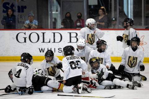 The Mavericks tackle their goaltender after winning a 10U Jr. Golden Knights Hockey League game ...
