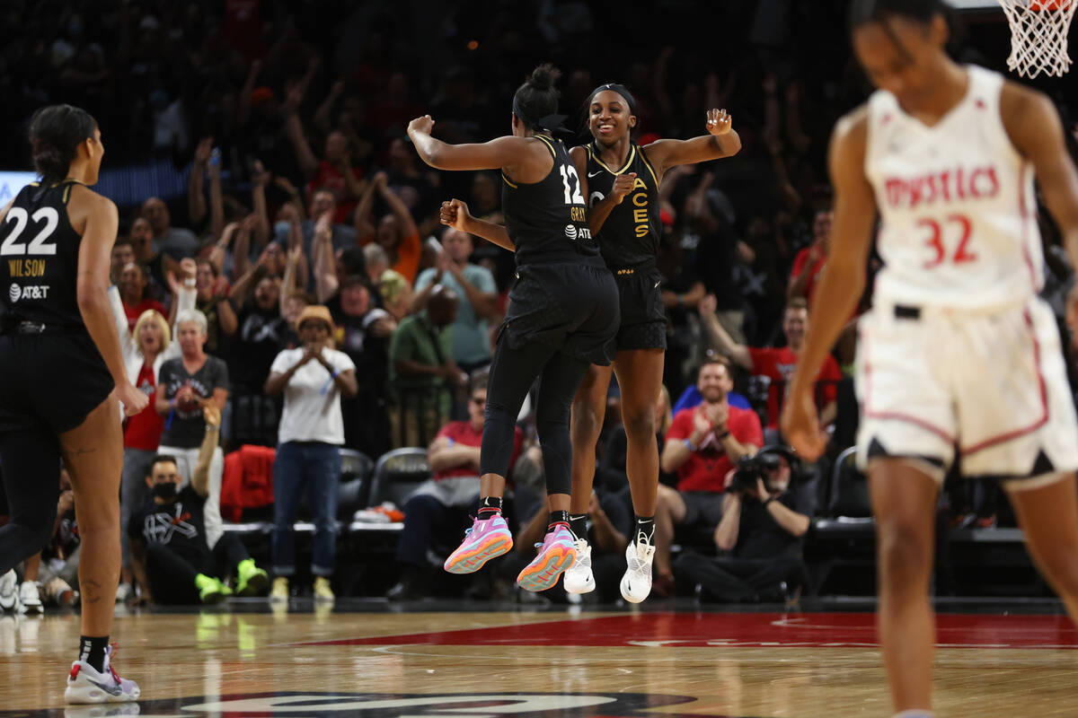 Las Vegas Aces guard Jackie Young (0) celebrates with guard Chelsea Gray (12) after scoring a t ...