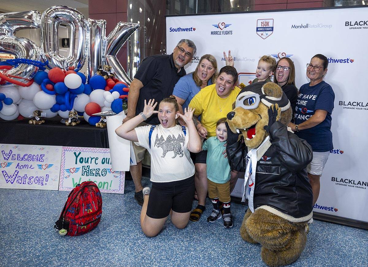 The Beas family gather for a silly group photo in the Terminal 1 baggage area during Miracle Fl ...