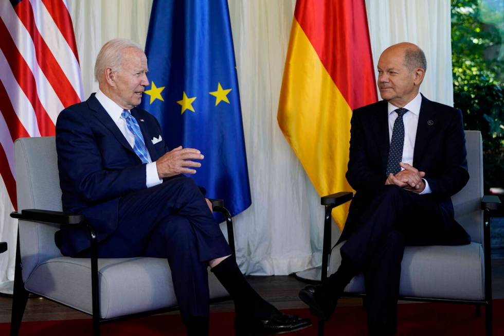 President Joe Biden and German Chancellor Olaf Scholz speak during a bilateral meeting at the G ...