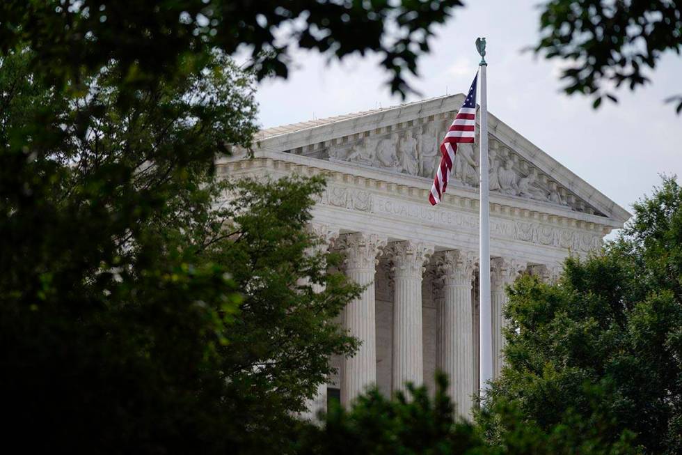 An American flag waves in front of the U.S. Supreme Court building, Monday, June 27, 2022, in W ...