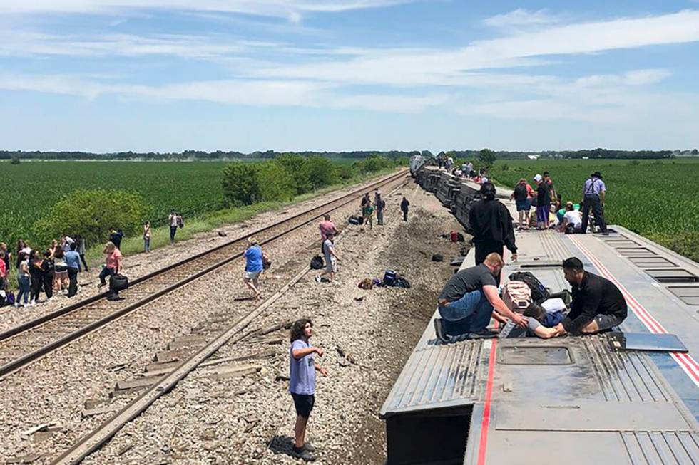 In this photo provided by Dax McDonald, an Amtrak passenger train lies on its side after derail ...