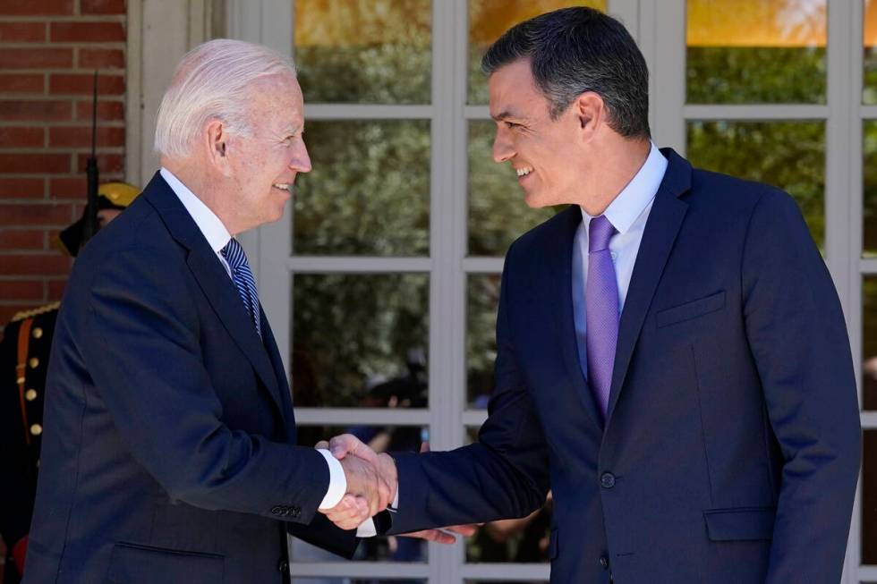 President Joe Biden and Spain's Prime Minister Pedro Sánchez shake hands as they meet at t ...