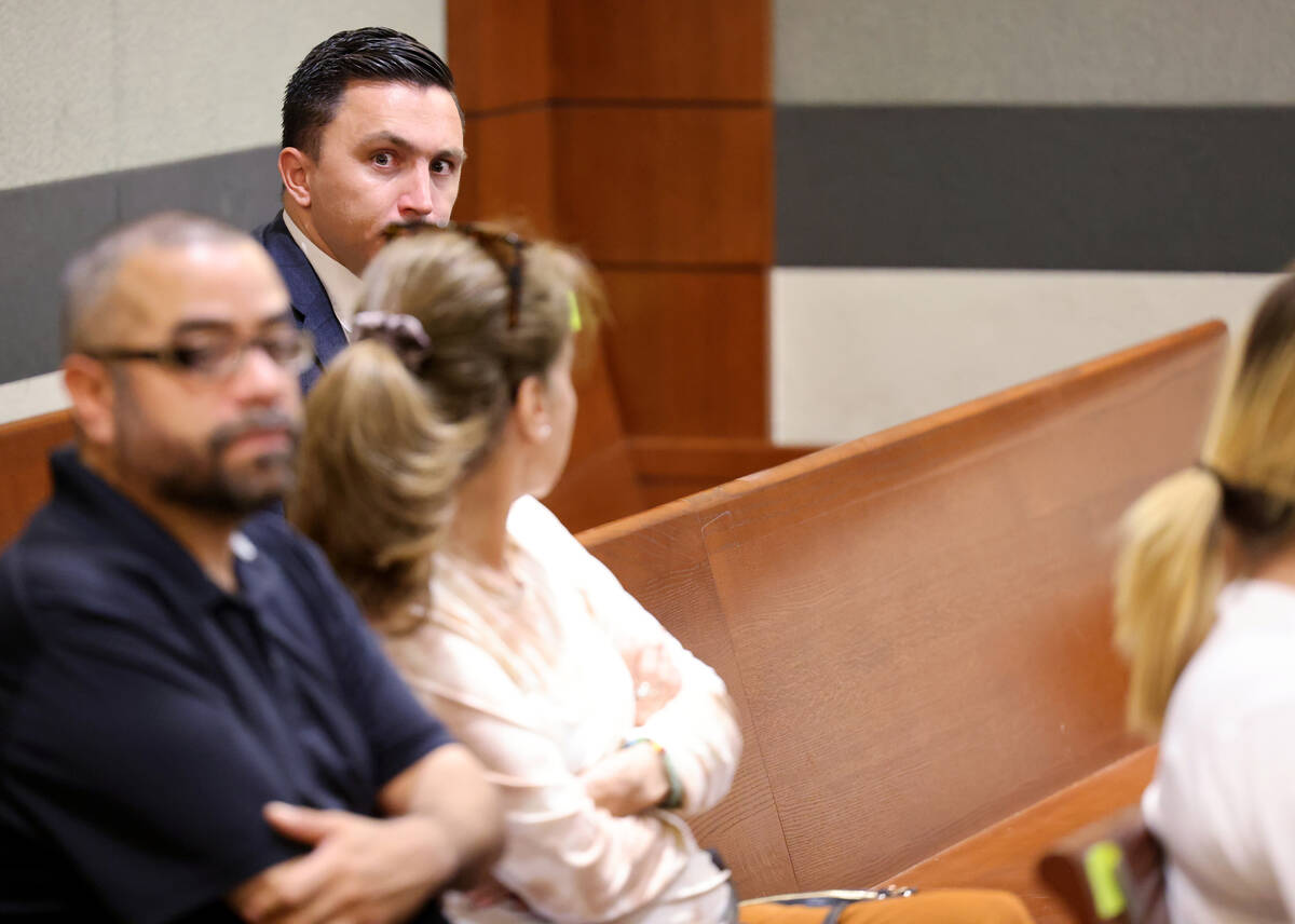 Political consultant Matthew DeFalco hides from a photographer before appearing in court at the ...