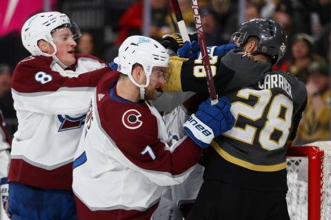 Vegas Golden Knights left wing William Carrier (28) gets physical with Colorado Avalanche defen ...
