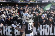 Oakland Raiders tight end Darren Waller (83) fires up the crowd in the "Black Hole" at the Oakl ...
