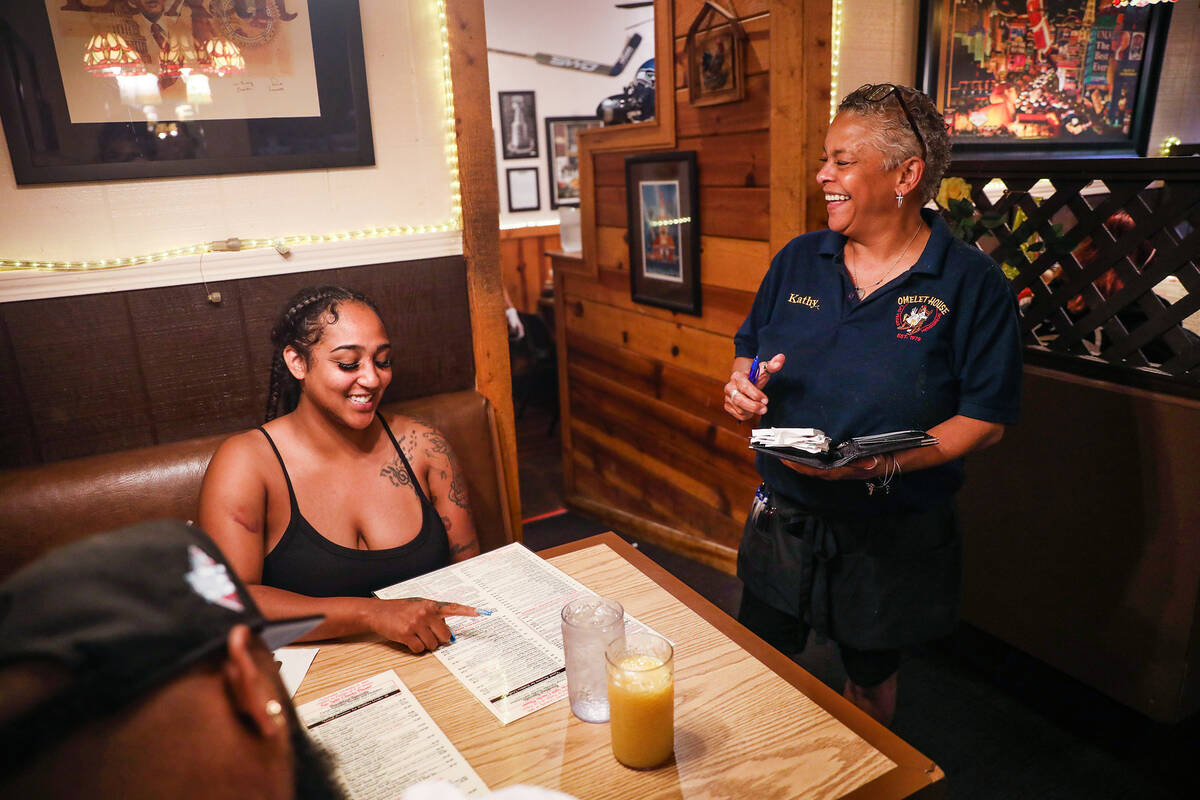 Server Kathy Takos takes a food order from Breeanna Frias at The Omelet House at their central ...