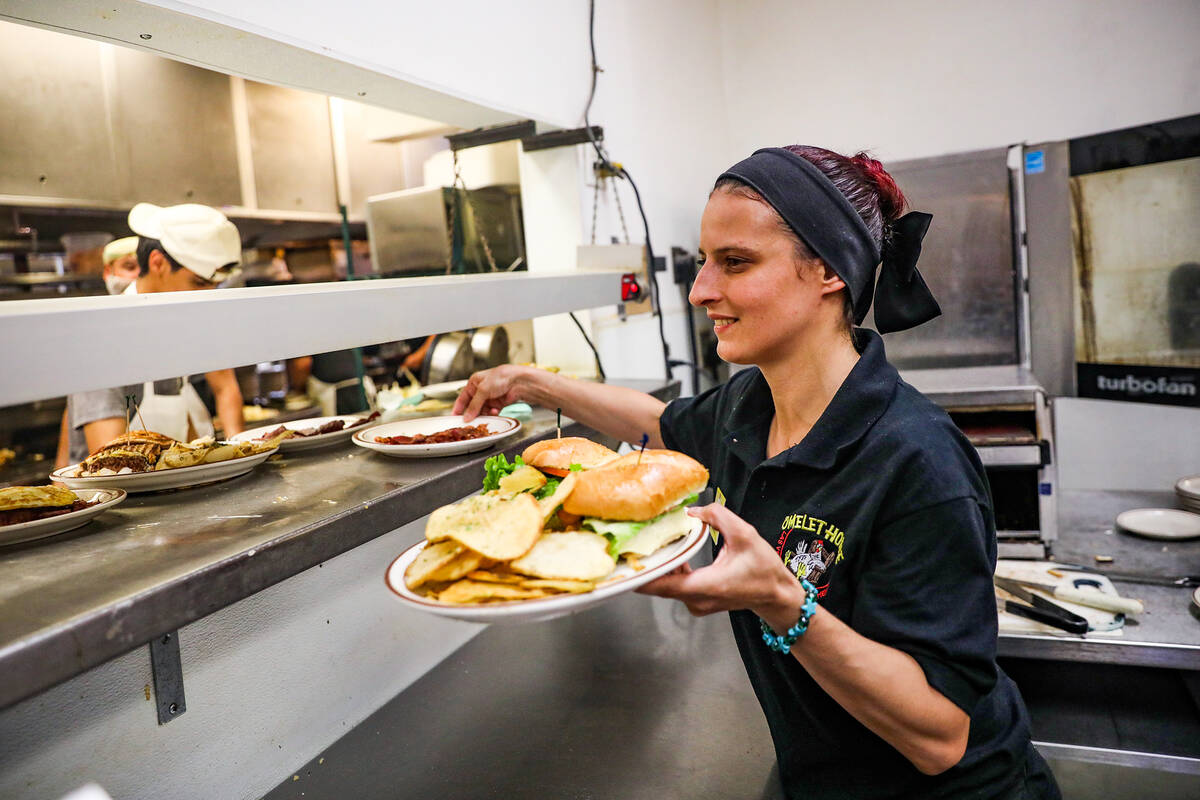 Server Brittney Crocker grabs food to expedite at The Omelet House at their central Las Vegas l ...