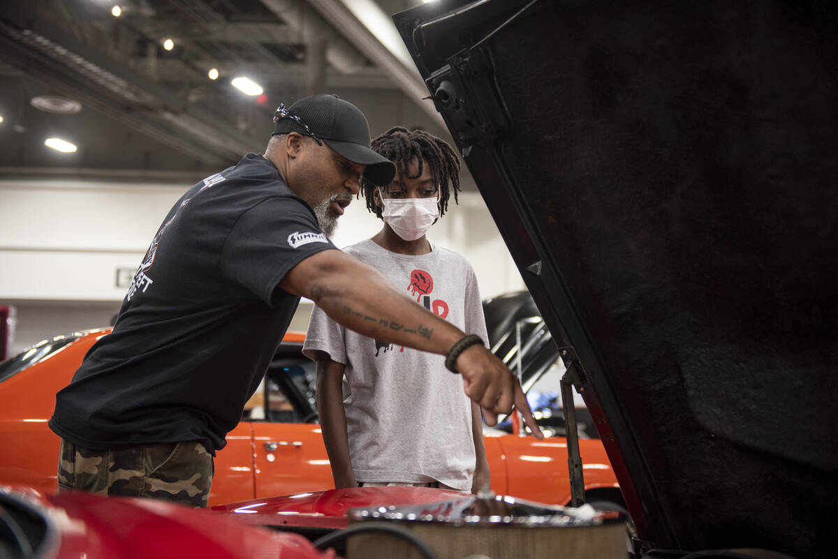 Will Brown, left, and his son Nicolas Brown look under the hood of a 1970 Chevrolet Corvette du ...