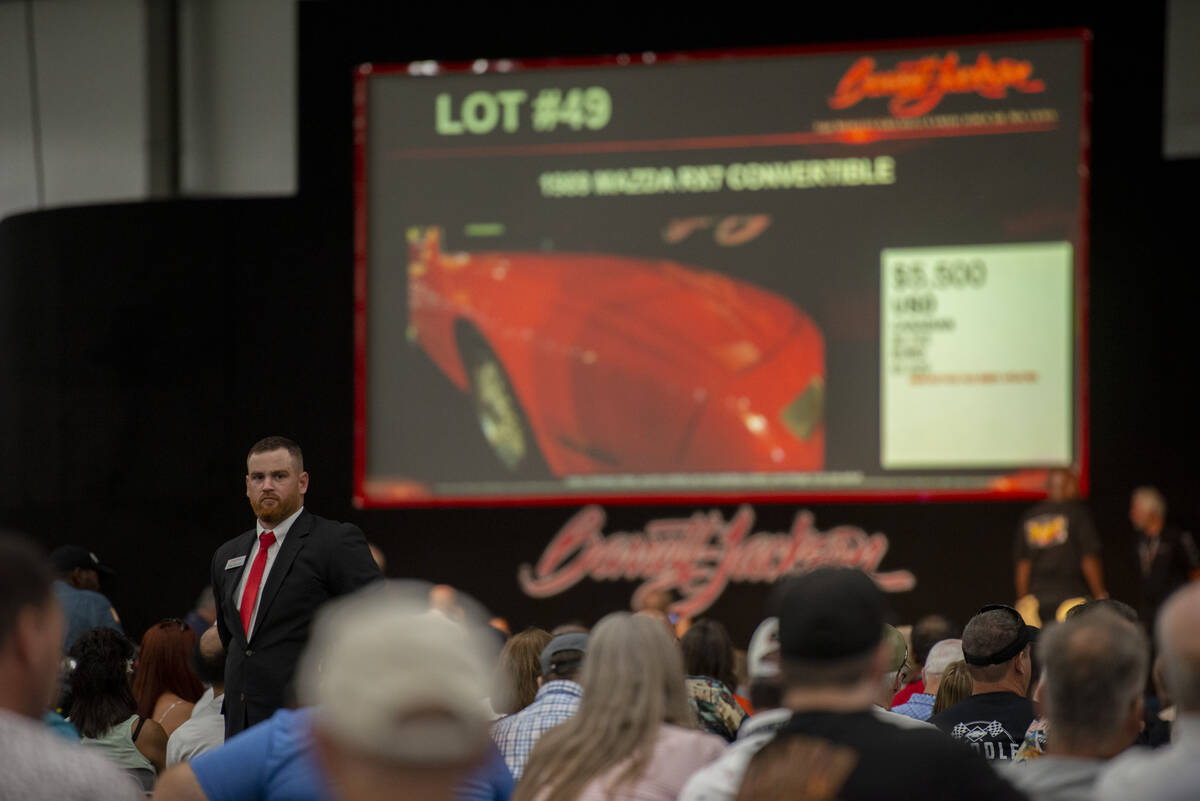 Auction staff keeps an eye out for bids during opening day of the Barrett-Jackson car auction a ...