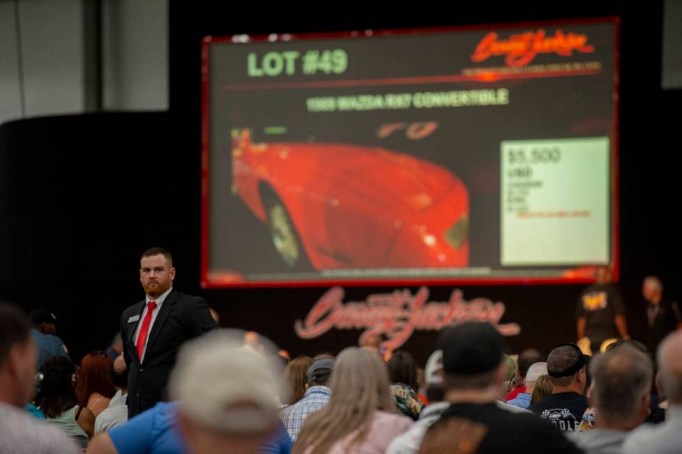 Auction staff keeps an eye out for bids during opening day of the Barrett-Jackson car auction a ...