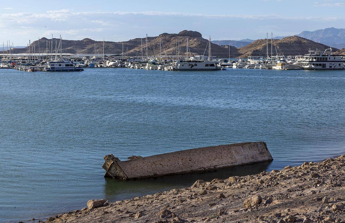 A WWII-era landing craft used to transport troops or tanks being is revealed on the shoreline n ...