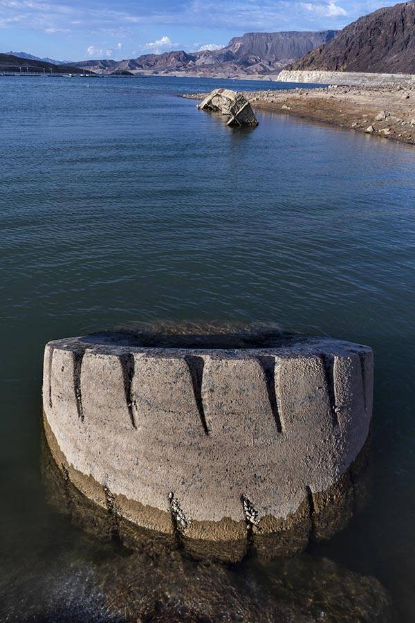 A WWII-era landing craft used to transport troops or tanks, and large tire nearby, are being re ...