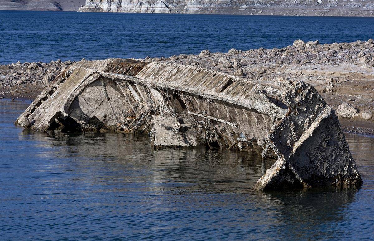 A WWII-era landing craft used to transport troops or tanks is being revealed on the shoreline n ...