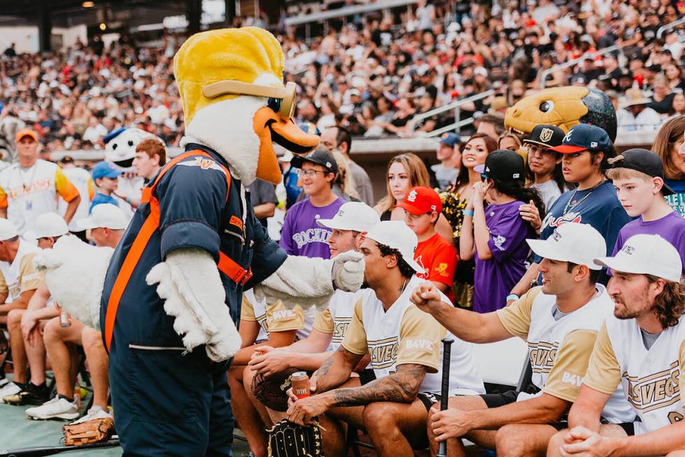 Aviators mascot Spruce greets Golden Knights players during the 2021 Battle for Vegas charity s ...