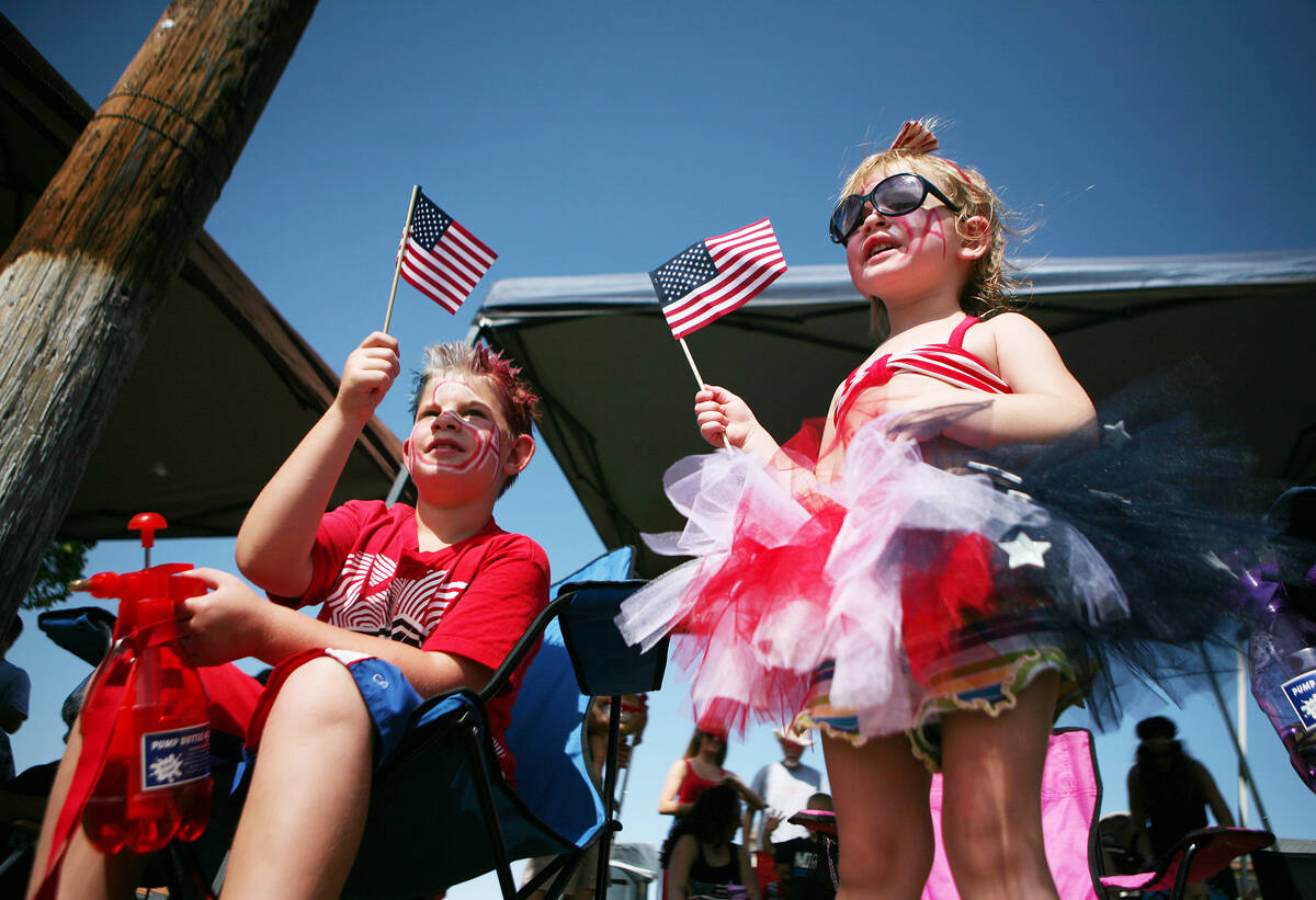 In this July 4, 2014, file photo, Chase, 8, left, and Rainey Easter, 2, watch the 66th Annual B ...