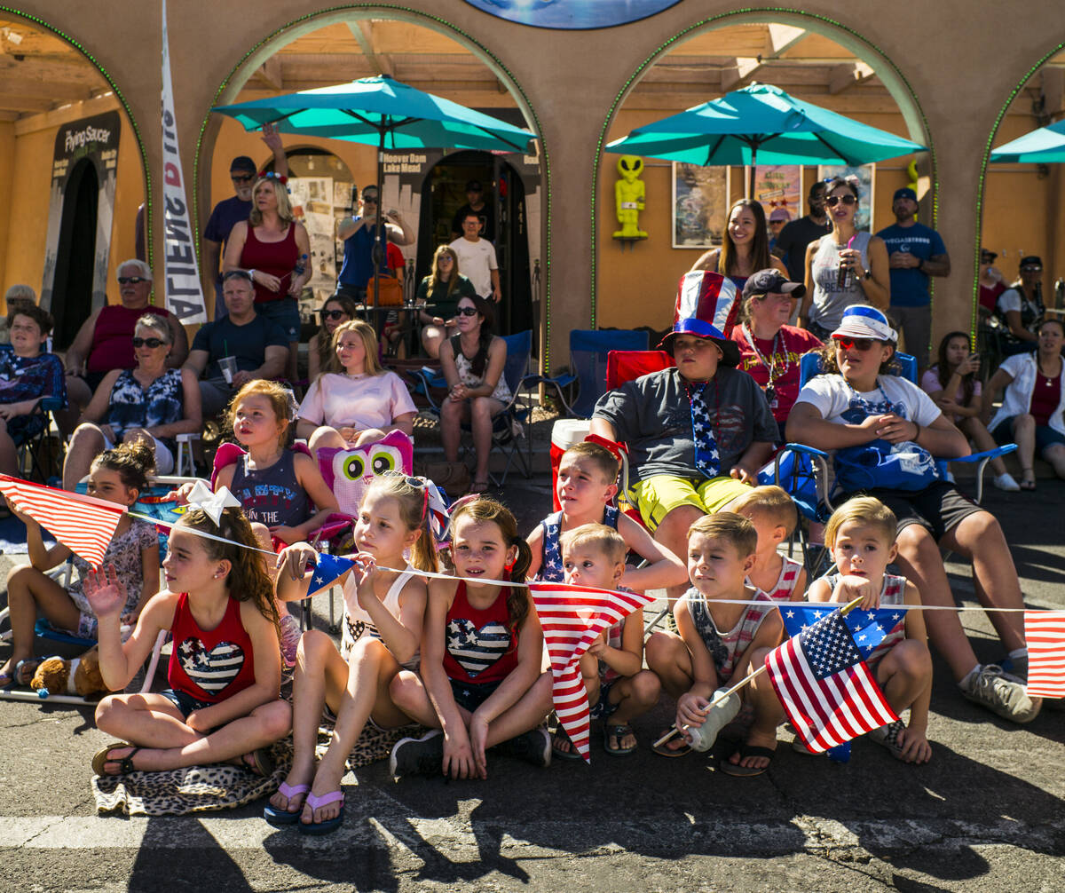In this July 4, 2019, file photo, young spectators watch parade participants pass by at the ann ...