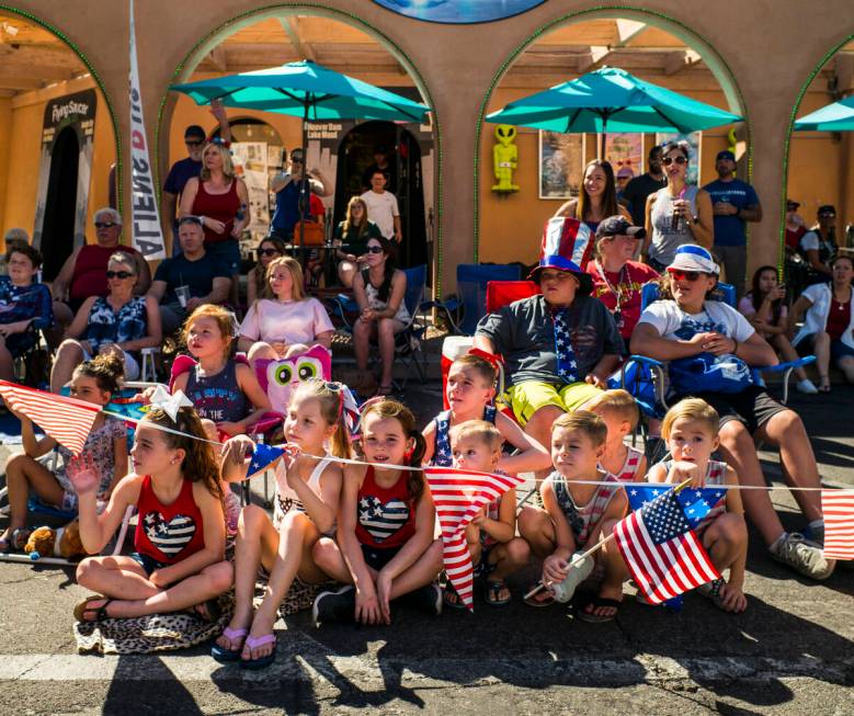 In this July 4, 2019, file photo, young spectators watch parade participants pass by at the ann ...