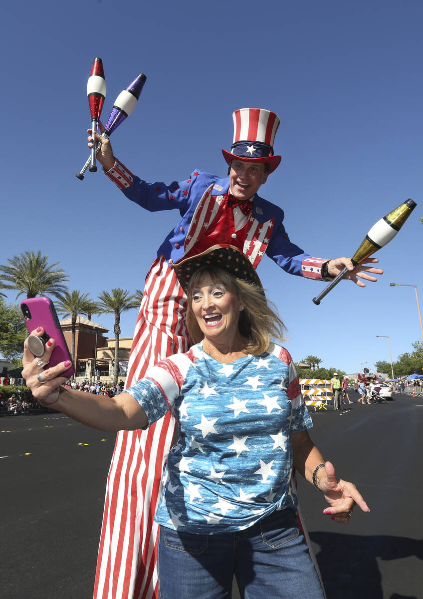 In this July 4, 2019, file photo, Kathy Koch takes a photo with a man dressed as Uncle Sam duri ...