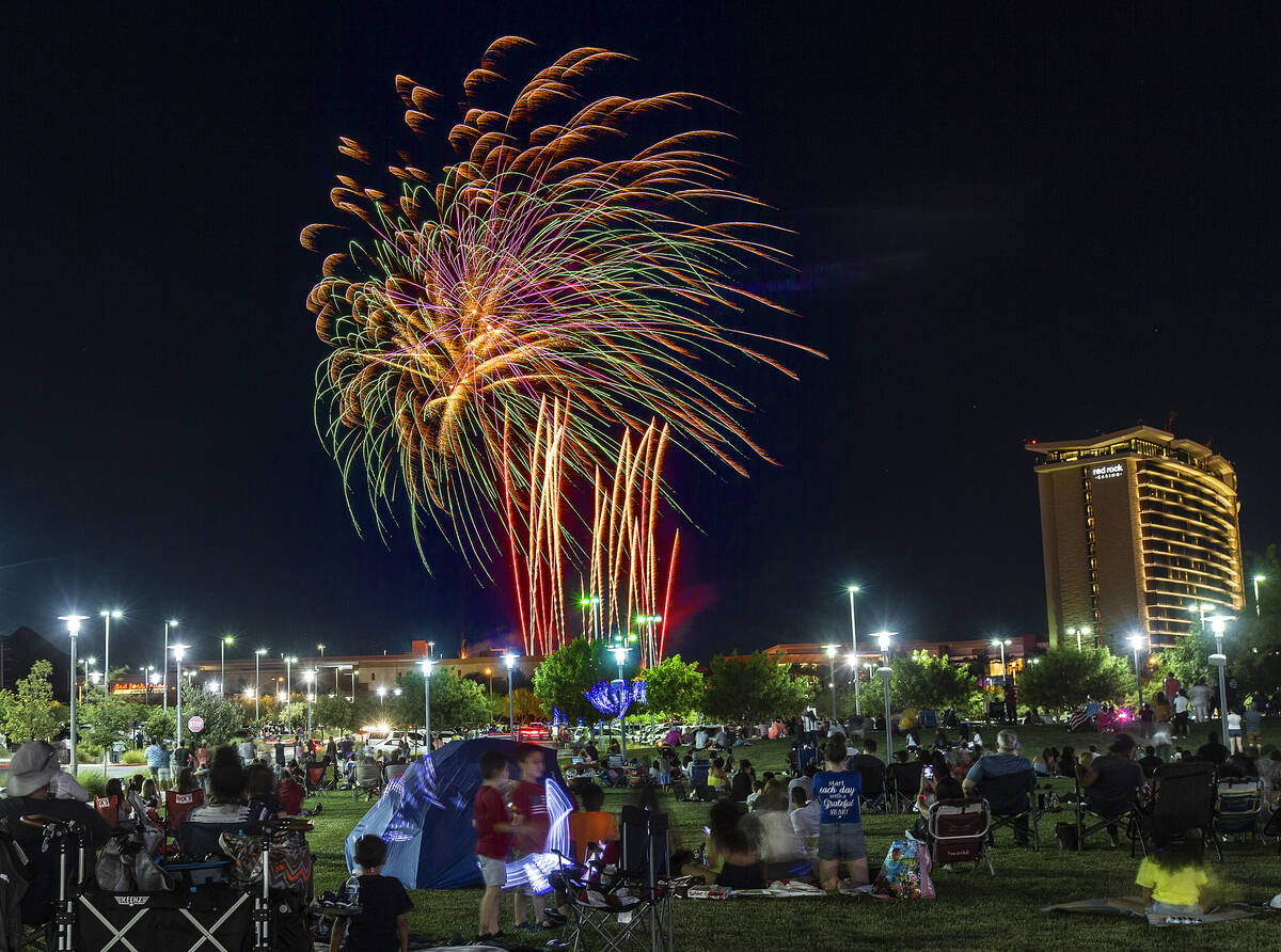 In this July 4, 2020, file photo, people watch the Red Rock Casino fireworks show from Downtown ...