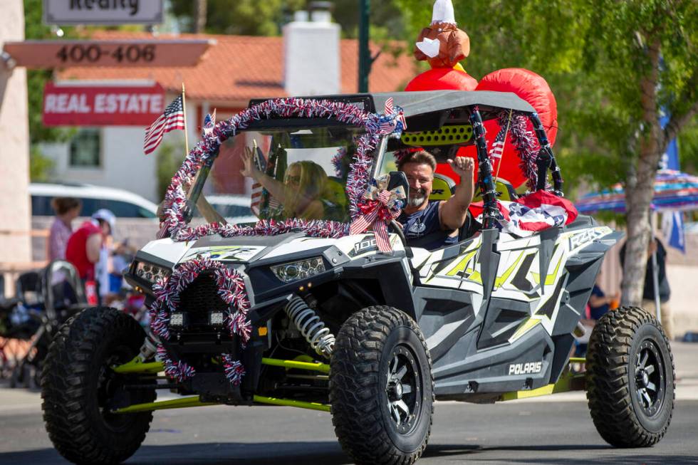 In this July 3, 2021, file photo, a dune buggy passes through the parade route during the two-d ...
