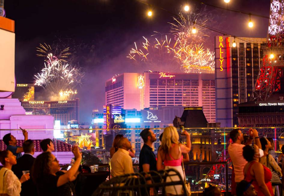 In this July 4, 2021, file photo, people watch as fireworks explode over the Las Vegas Strip du ...