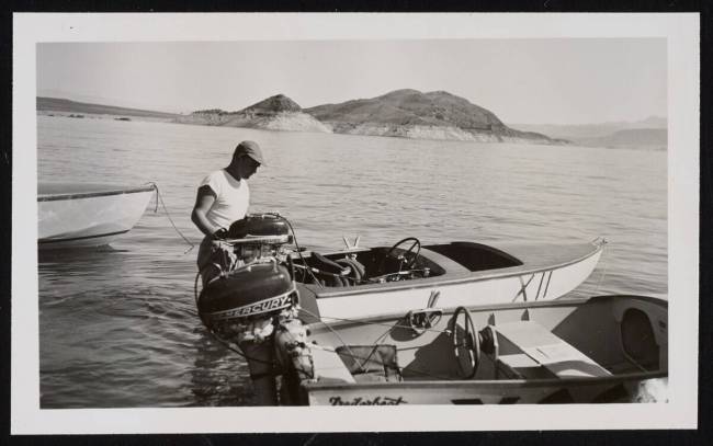 Unidentified man stands with boat used for racing on Lake Mead in 1950. (United States National ...