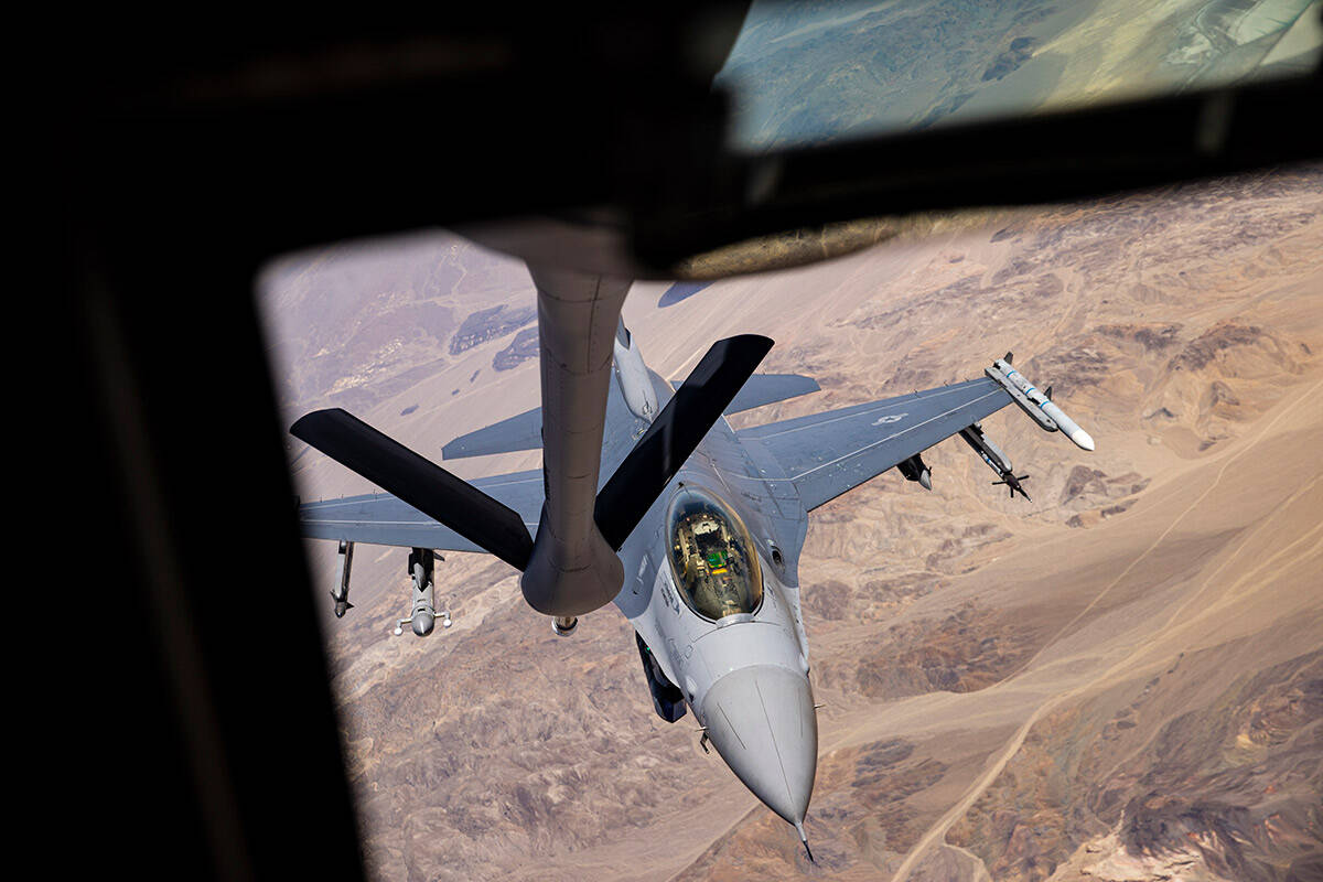 Airman first class Jonathon Covey, not pictured, operates the boom in order to refuel an F-16 i ...