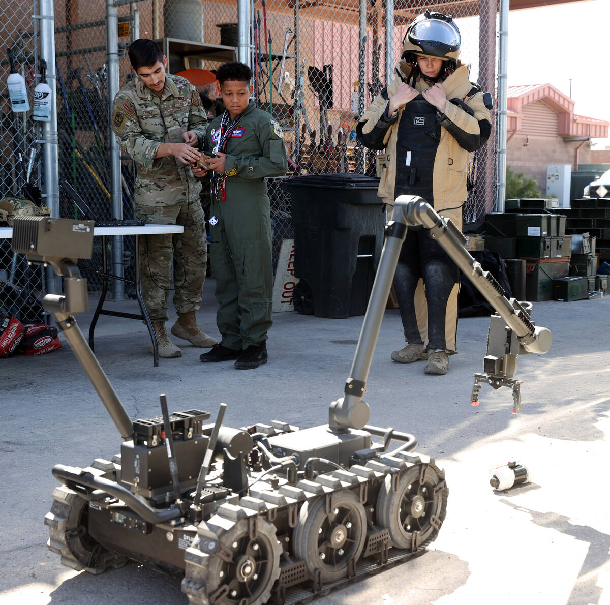 Willians Urrutia-Mejia Jr., 12, operates an explosive ordnance disposal robot with Airman First ...