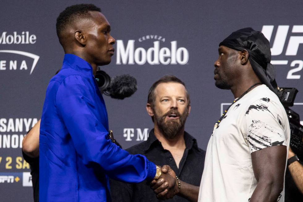 Israel Adesanya, left, and Jared Cannonier, face off during an UFC 276 press conference at T-Mo ...