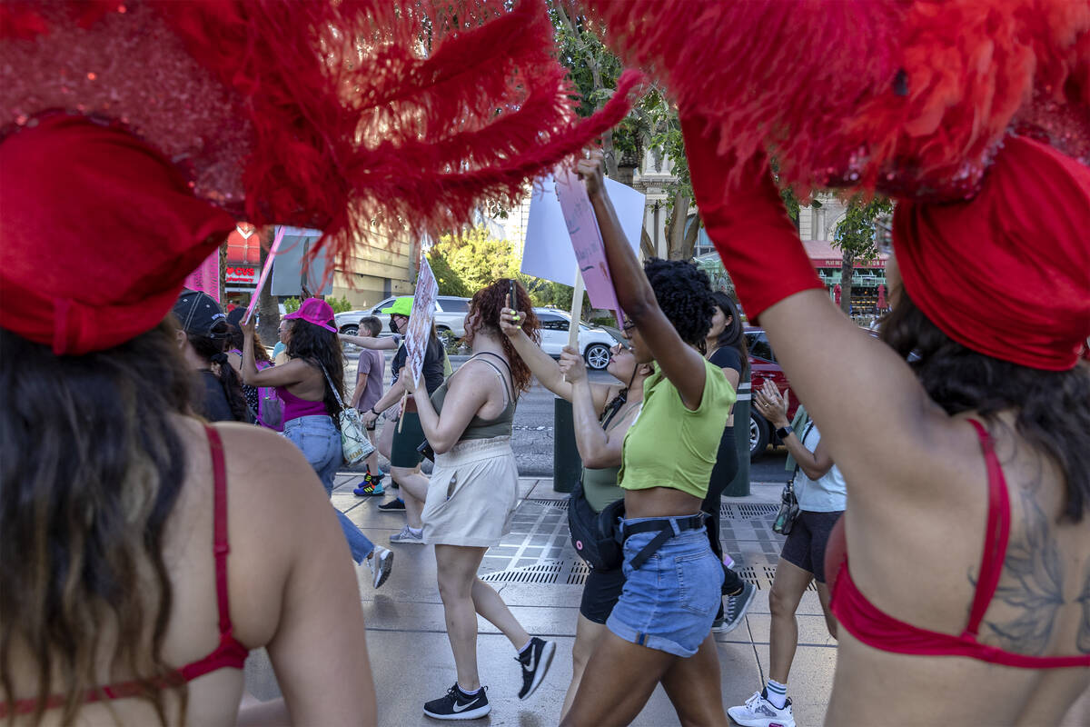 A rally for women’s rights passes showgirls at the Bellagio Fountain, Friday, July 1, 20 ...