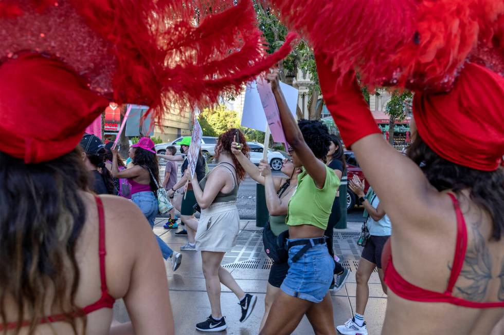 A rally for women’s rights passes showgirls at the Bellagio Fountain, Friday, July 1, 20 ...