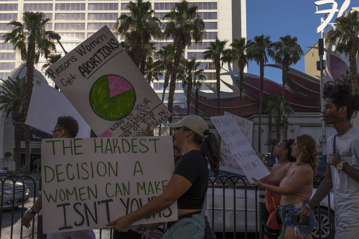 Protesters pass Flamingo Las Vegas during a rally for women’s rights, Friday, July 1, 20 ...